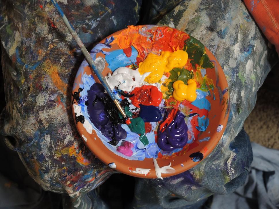 Free Image of Person Holding Bowl of Paint and Brush 
