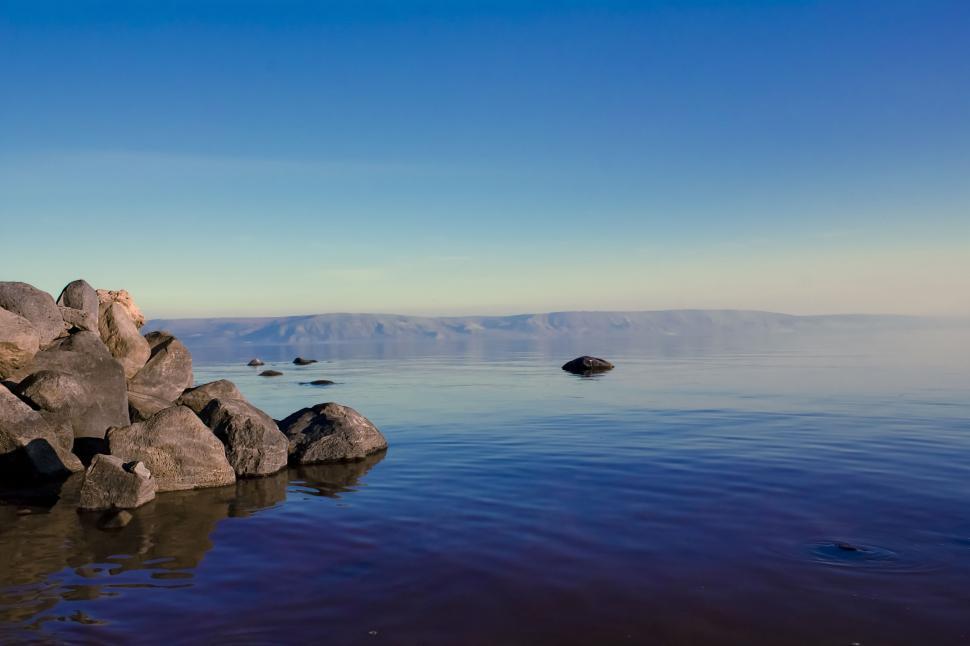 Free Image of Large Rock Amidst Body of Water 