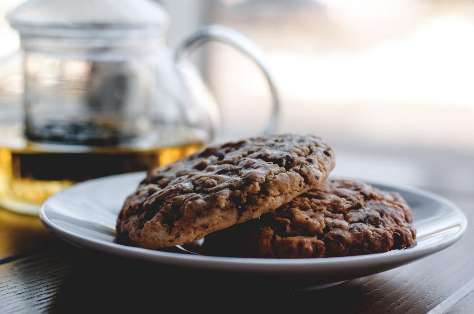 Free Image of Two Cookies on a Plate With Glass of Tea 