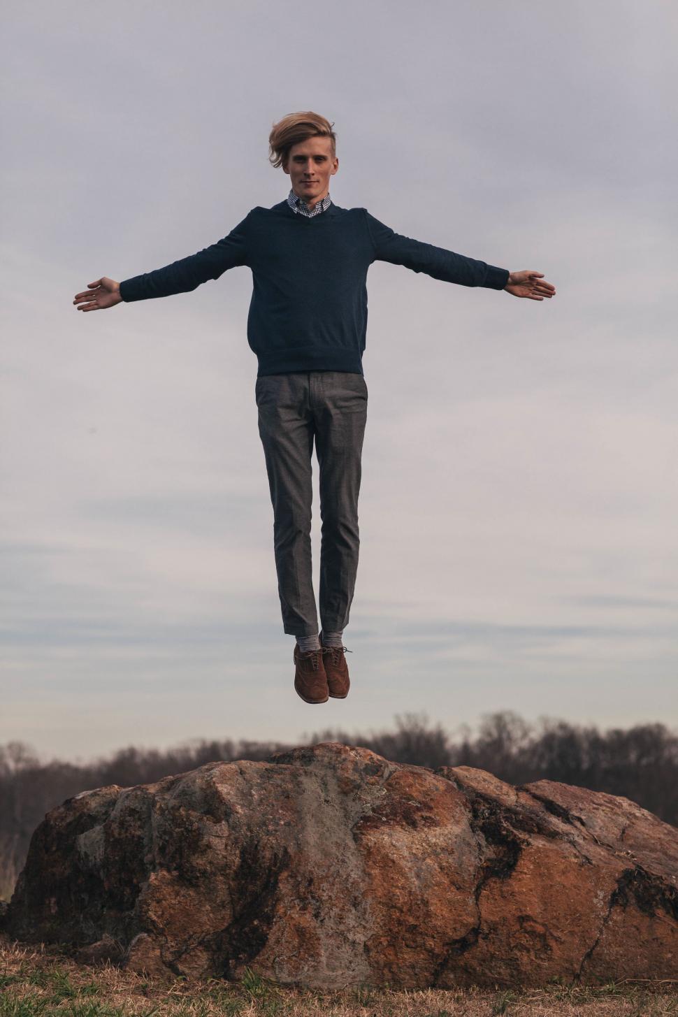 Free Image of Man Jumping in the Air With Outstretched Arms 