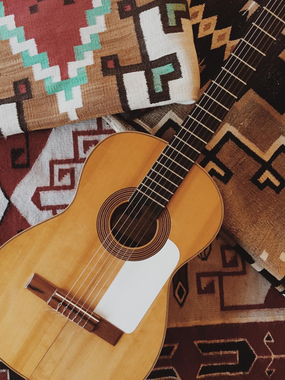 Free Image of Wooden Guitar on Rug 