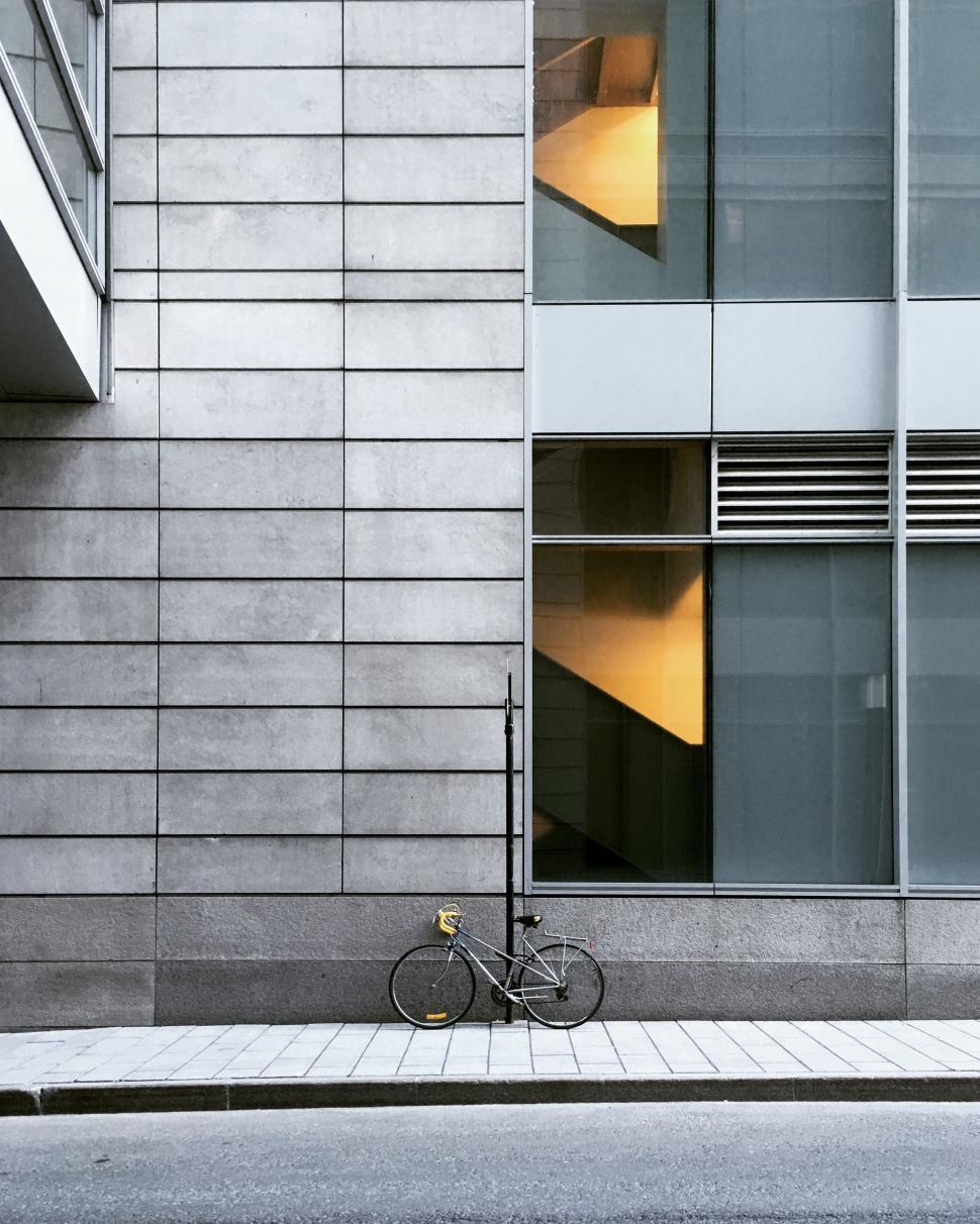 Free Image of Bike Parked Next to Tall Building 