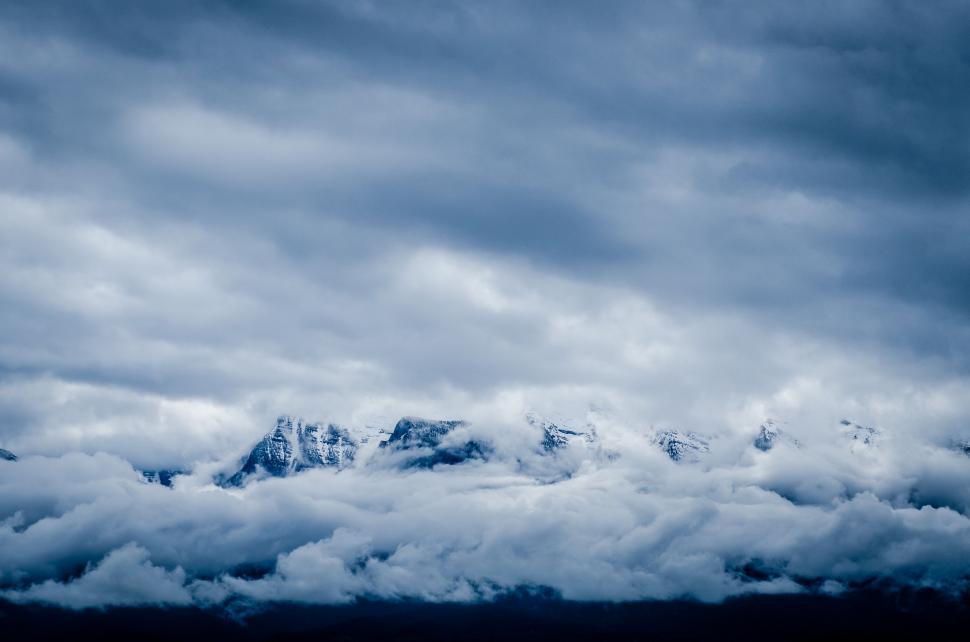 Free Image of Majestic Mountain Enshrouded in Clouds 