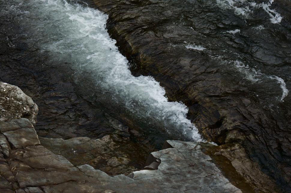 Free Image of Man Standing on Cliff by River 