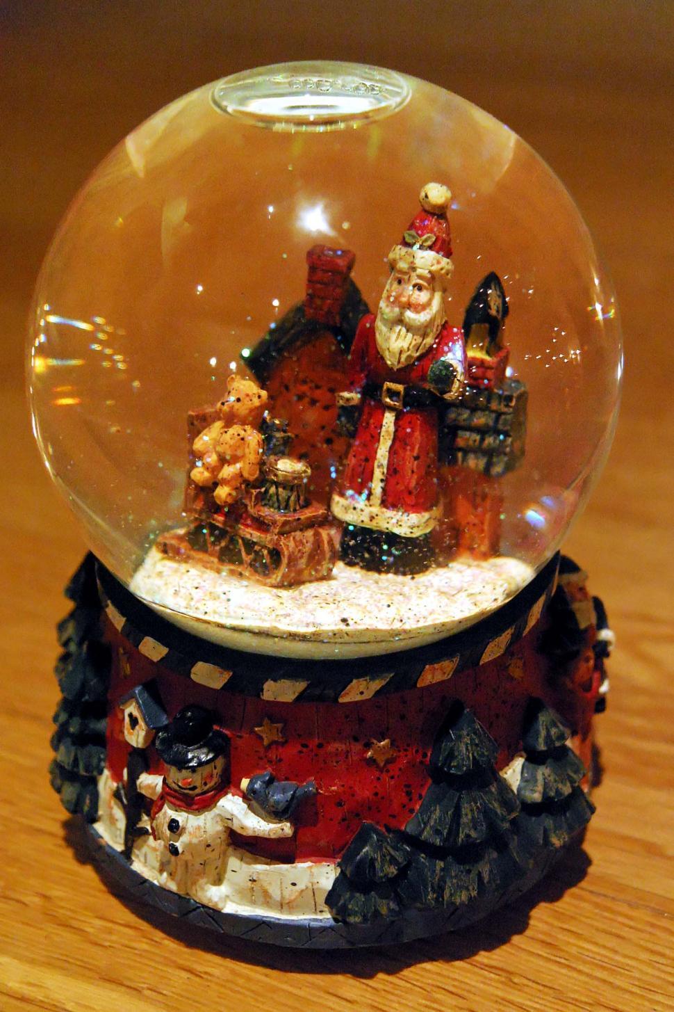 Free Image of christmas holiday holidays decoration claus santa toy carvings carved wooden doll figurine figure snow globe teddy bear sphere 