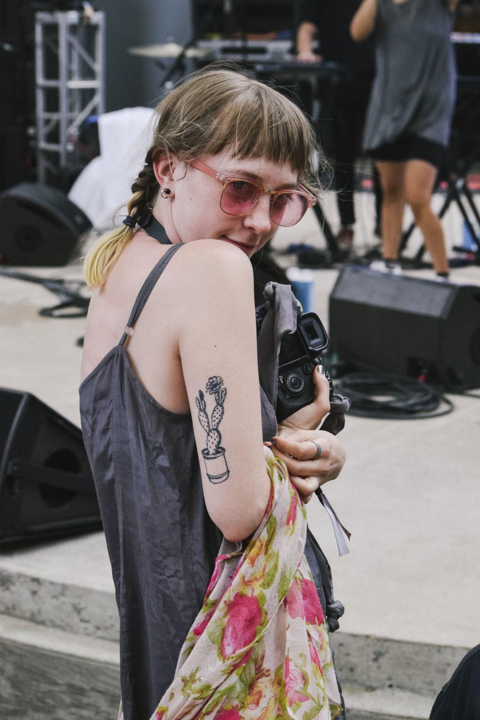 Free Image of Woman With Tattoo Holding Camera 
