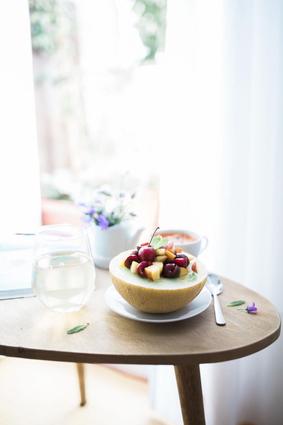 Free Image of Bowl of Fruit and Glass of Water on Table 