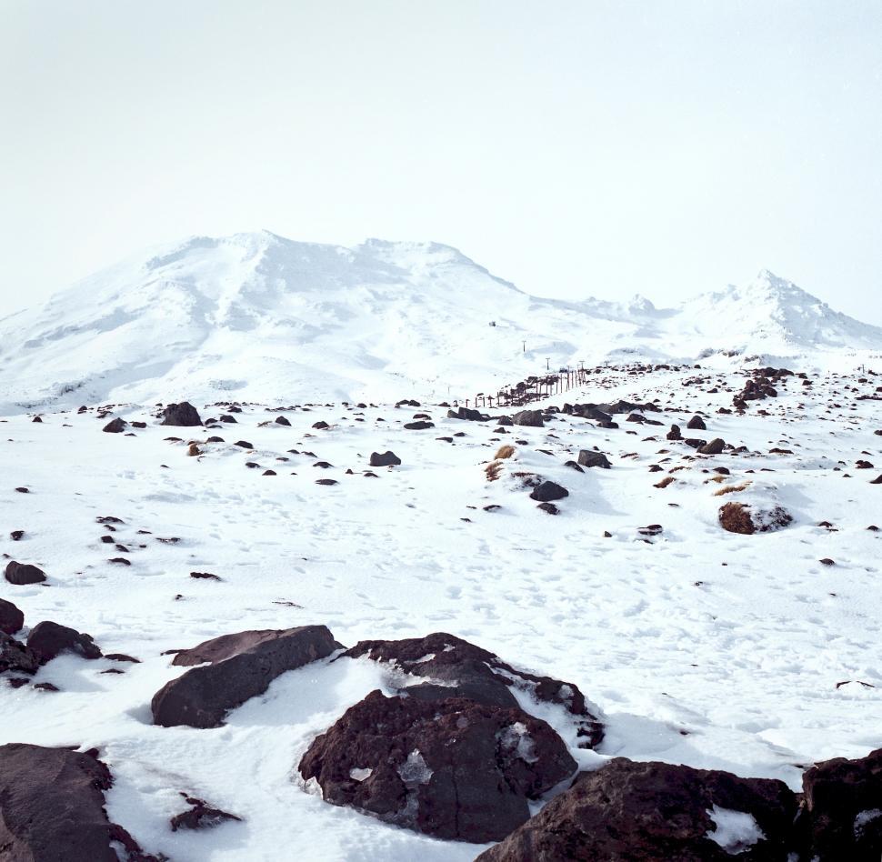 Free Image of Snow-Covered Mountain With Rocks and Snow 