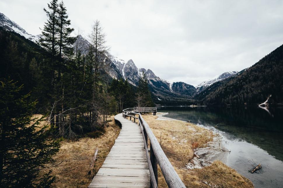 Free Image of Wooden Walkway Leading to Lake With Mountains 