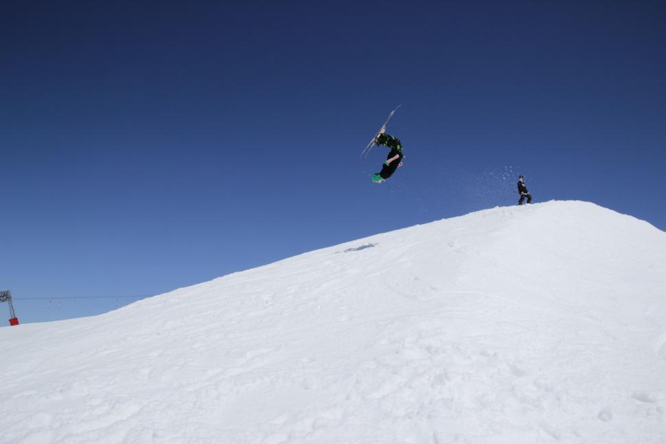 Free Image of Man Flying Through the Air on Snowboard 