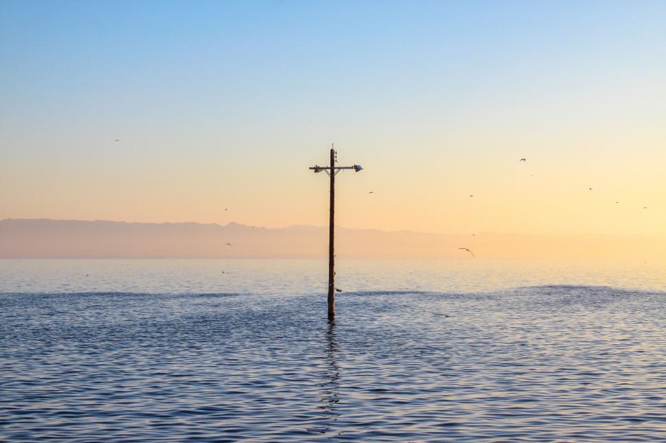 Free Image of Pole in the Middle of the Ocean at Sunset 