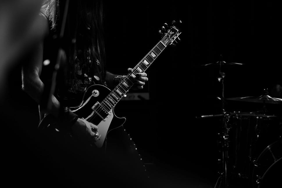 Free Image of Man Playing Guitar in Black and White 
