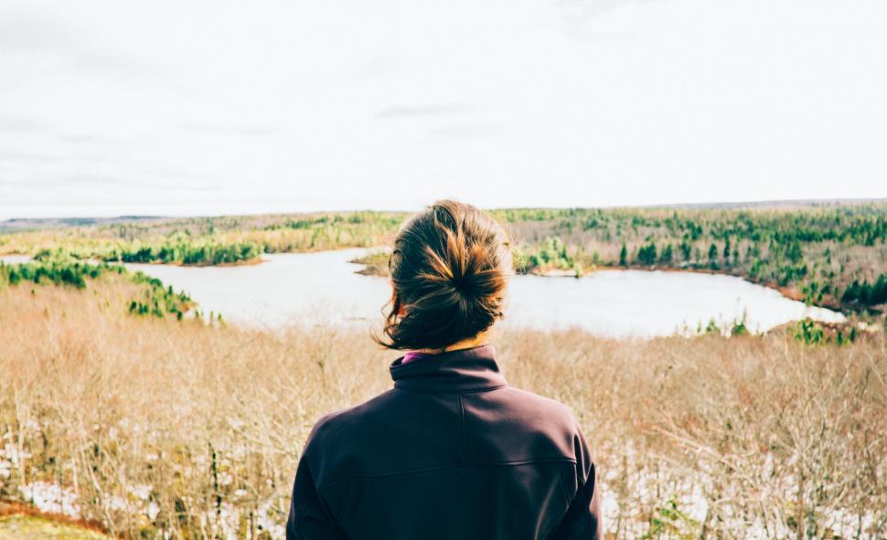 Free Image of Person Standing on Hill Looking at Lake 