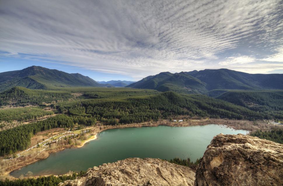 Free Image of Lake Surrounded by Mountains Under Cloudy Sky 