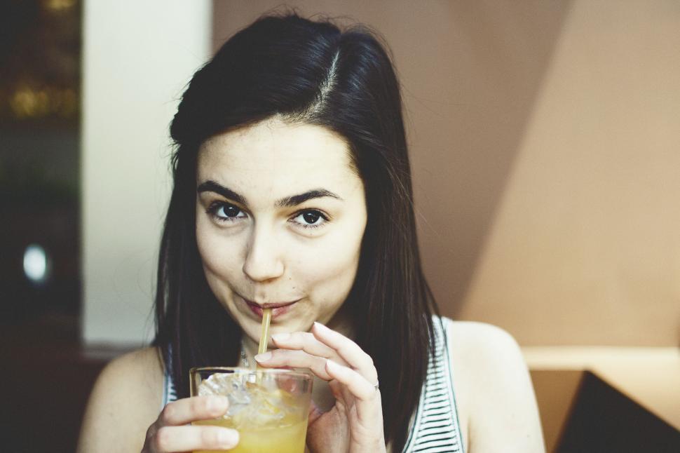 Free Image of Woman Drinking Glass of Orange Juice 