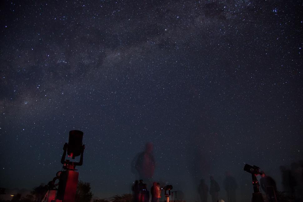 Free Image of Group of People Gazing Up at Night Sky 