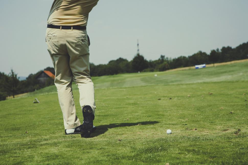 Free Image of Man Swinging Golf Club on Golf Course 