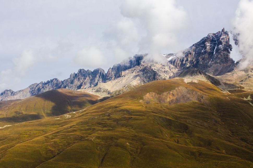 Free Image of Majestic Mountain Range Under Cloudy Sky 