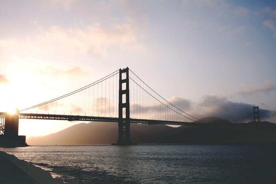 Free Image of Golden Gate Bridge Silhouetted Against Cloudy Sky 