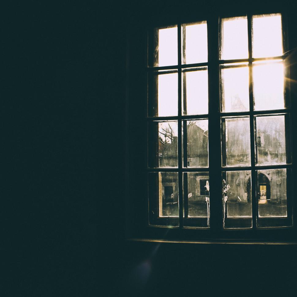 Free Image of Sunlight Shining Through a Window in a Dark Room 