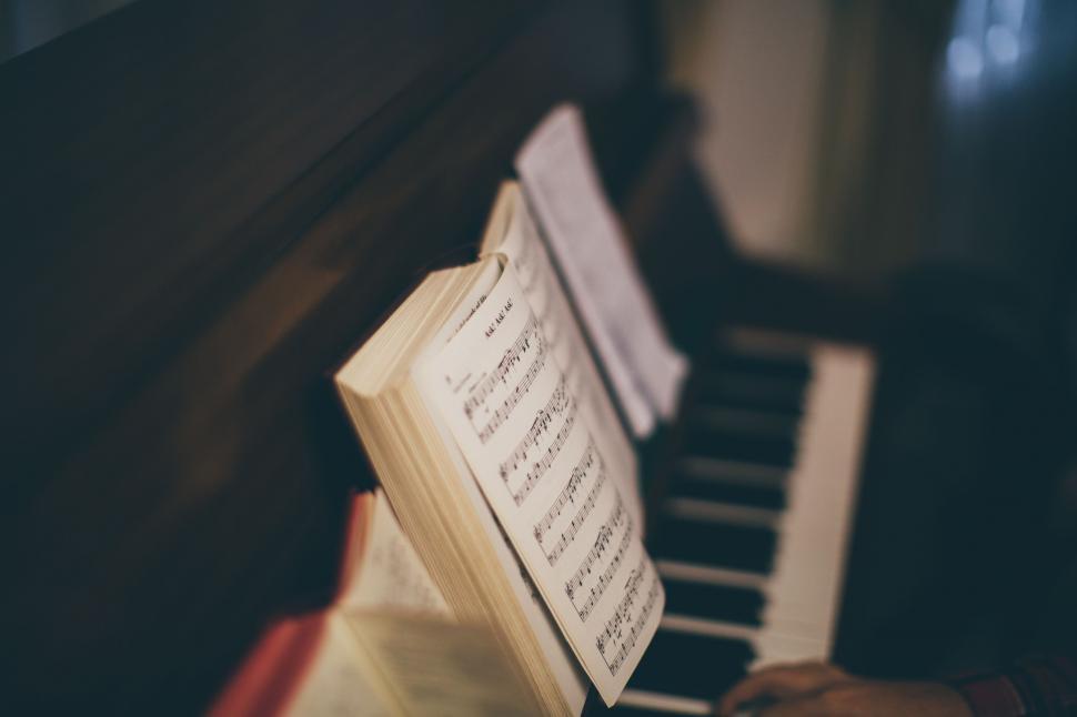 Free Image of Person Playing Piano With Sheet Music 