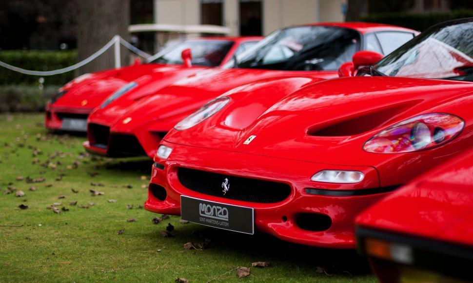 Free Image of Row of Red Sports Cars Parked Next to Each Other 