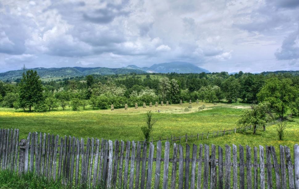 Free Image of Field With Wooden Fence and Mountains 