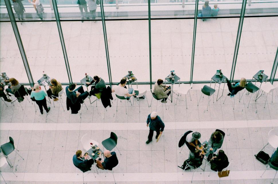 Free Image of Group of People Sitting at Tables Inside Building 