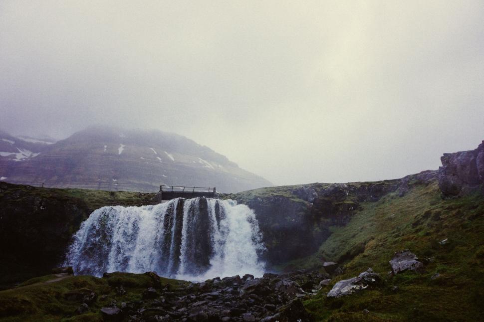Free Image of Waterfall Flowing Through Mountain Range 