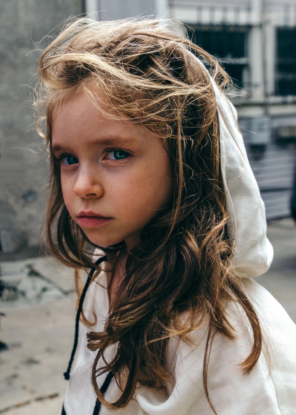 Free Image of Young Girl With Blue Eyes and a Hoodie 