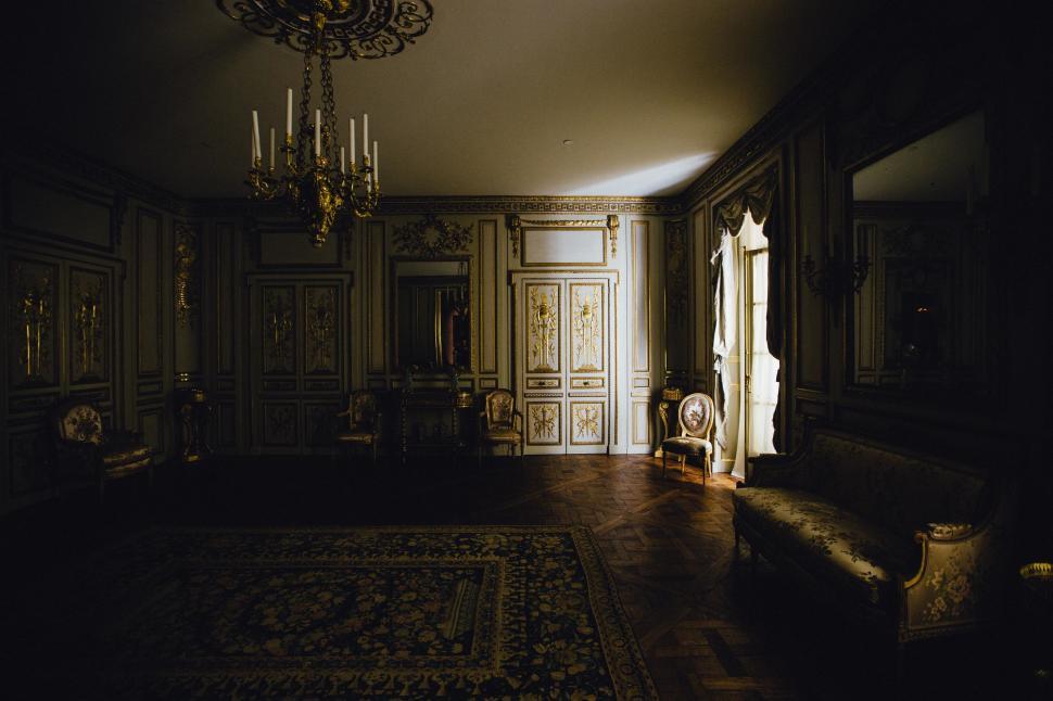 Free Image of Dark Room With Chandelier and Couch 