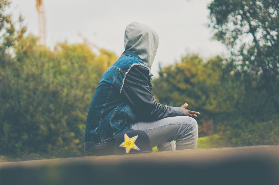 Free Image of Person With Hoodie Sitting on Bench 