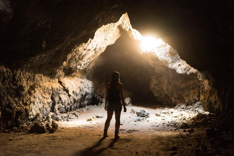 Free Image of Person Standing in Cave With Flashlight 