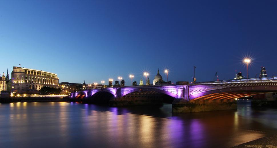 Free Image of Bridge Over River Glowing in Night Lights 