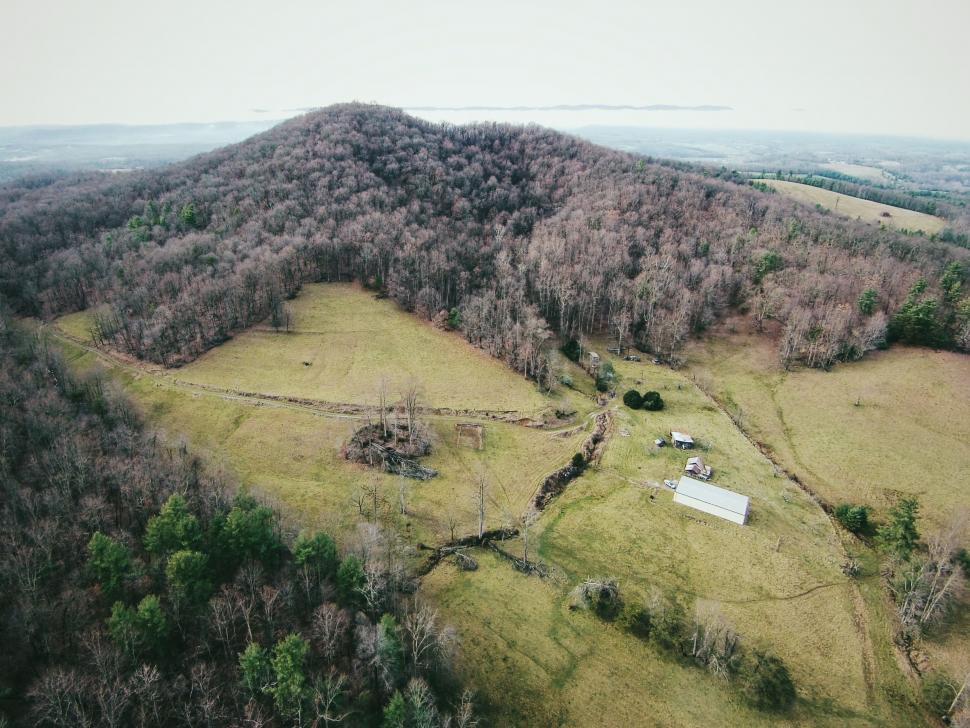 Free Image of Aerial View of a Farm Surrounded by Trees 