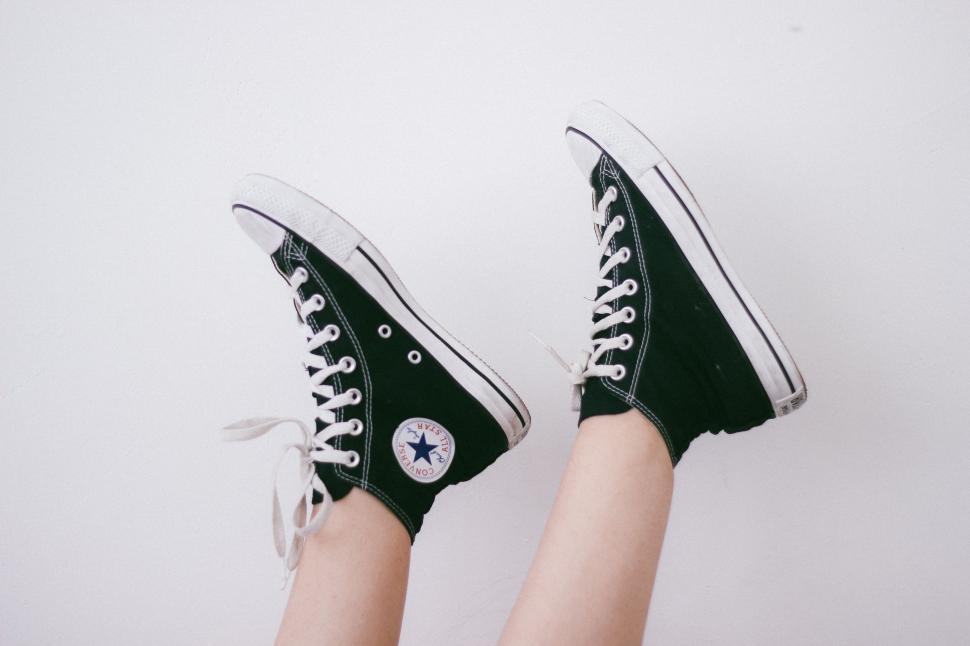 Free Image of Person Wearing Black and White Converse Shoes 