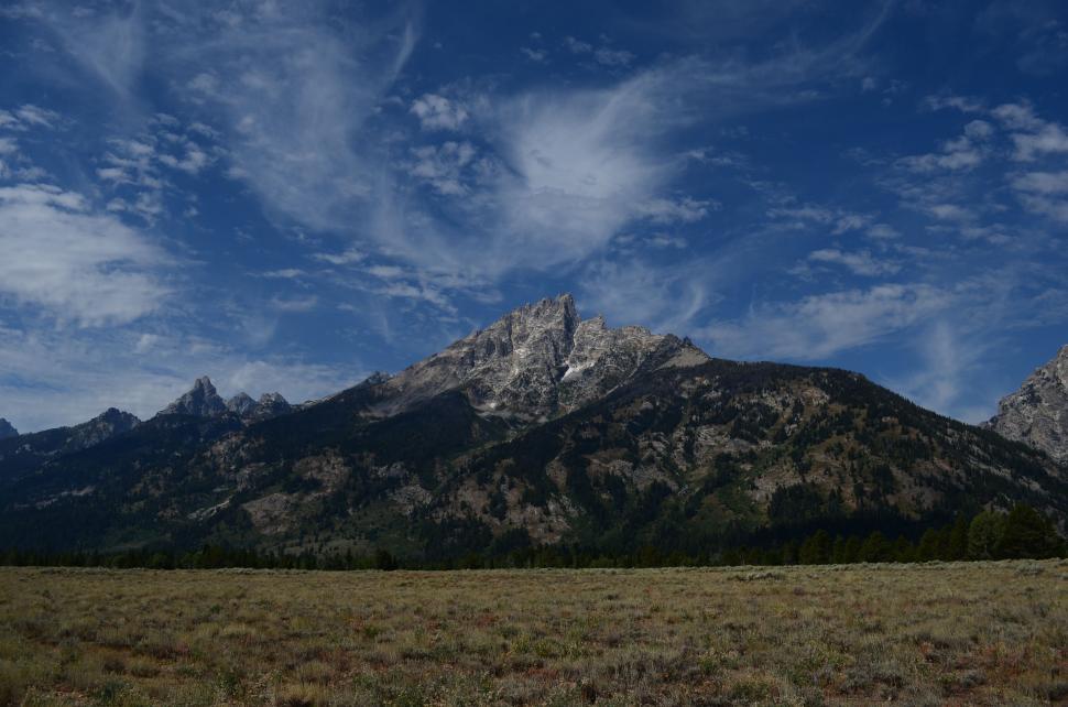 Free Image of Majestic Mountain Overlooking Vast Field 