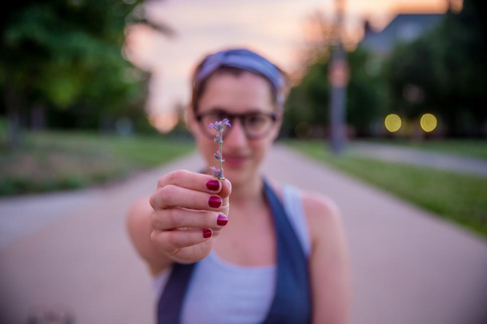 Free Image of Woman Holding Small Object in Hand 