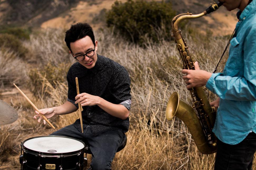 Free Image of Musicians Playing Instruments in a Field 