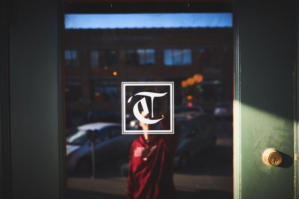 Free Image of Person in Red Robe Holding Up Sign 