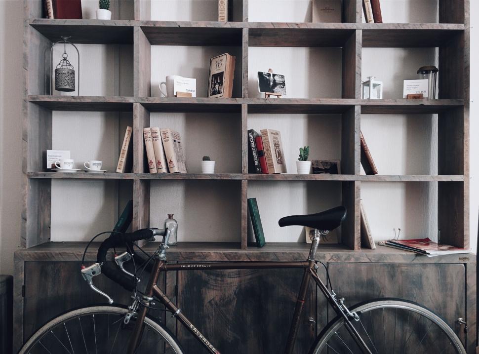 Free Image of Bike Parked in Front of Book Shelf 