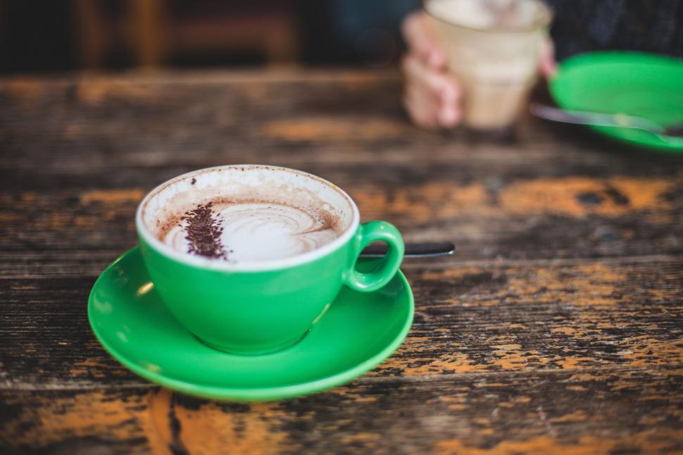 Free Image of Green Cup of Coffee on Wooden Table 