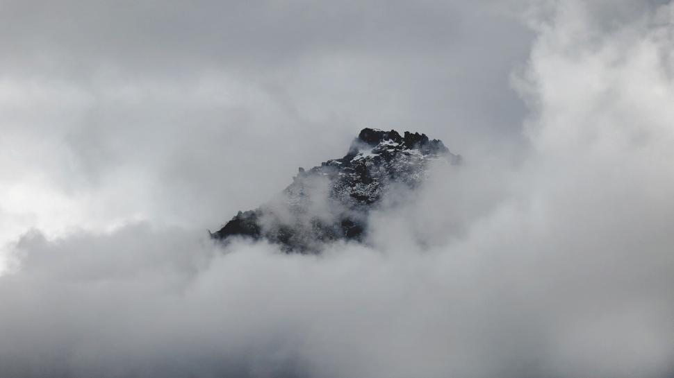 Free Image of Mountain Peak Enshrouded in Clouds 