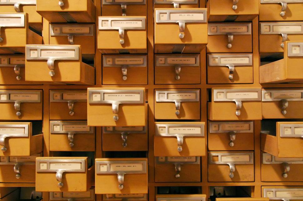 Free Image of card catalogue catalog drawers organization organized labels index cards handles pulls library furniture information open 