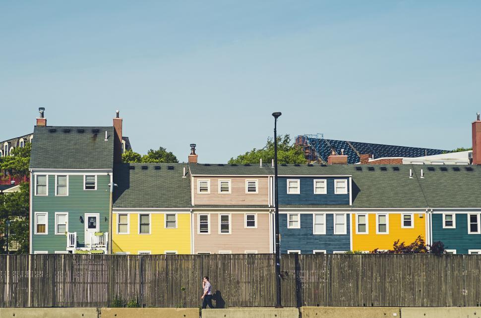 Free Image of Row of Multi-Colored Houses Next to Fence 