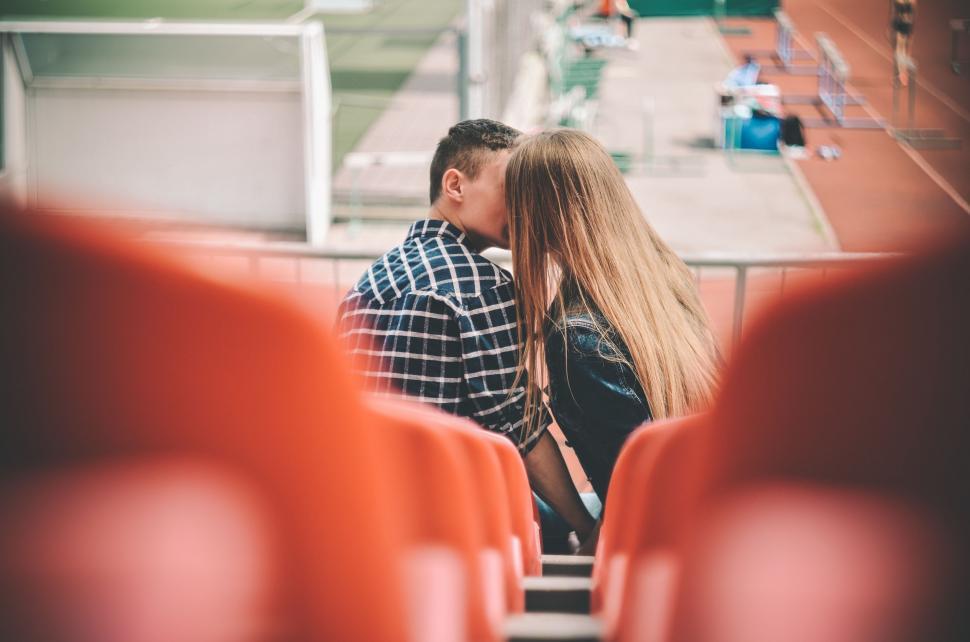 Free Image of Man and Woman Kissing in a Stadium 