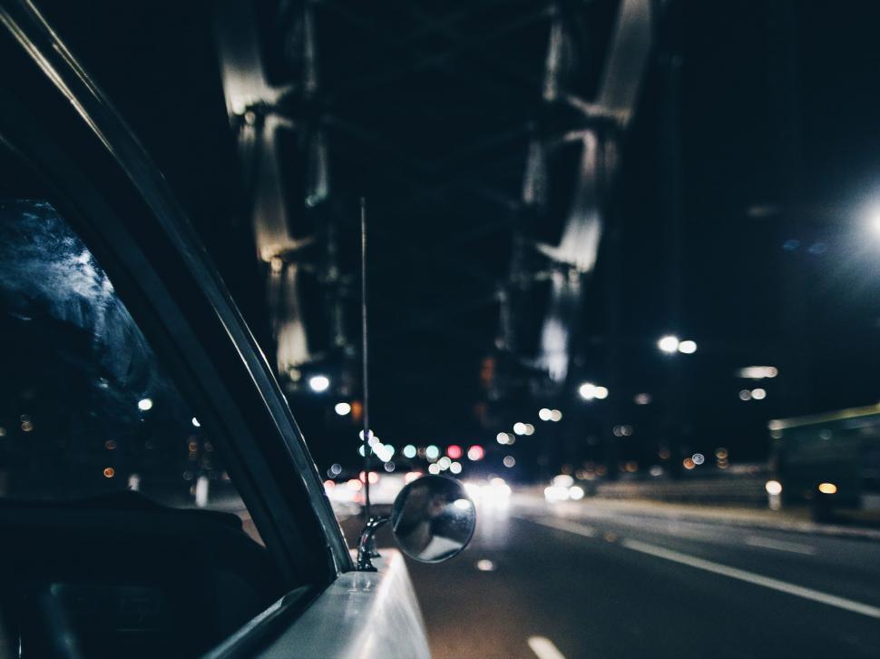 Free Image of Car Driving Down Street at Night 