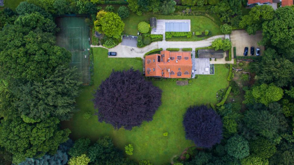 Free Image of Aerial View of a House Surrounded by Trees 