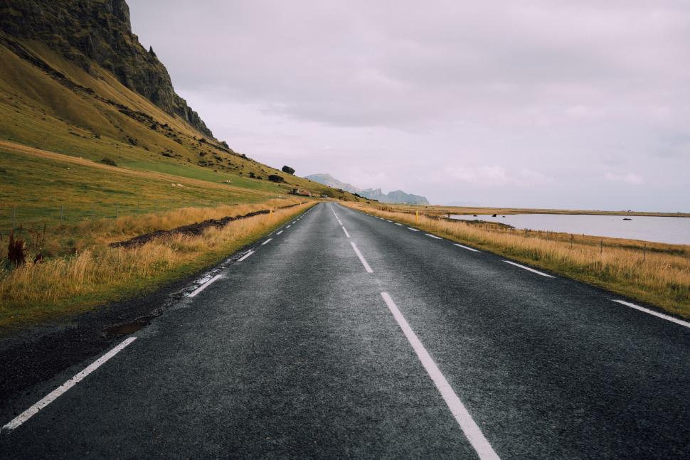 Free Image of Empty Road Cutting Through Grassy Field 