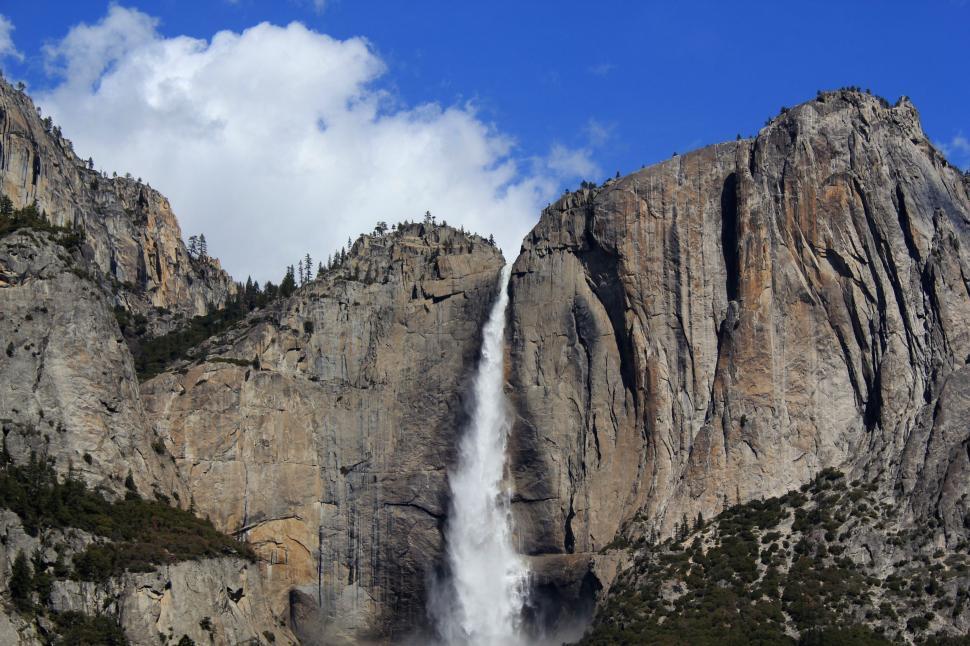Free Image of Large Waterfall Cascading From Side of Mountain 